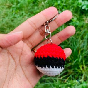 Pokeball crochet keychain handmade with red black and white yarn
