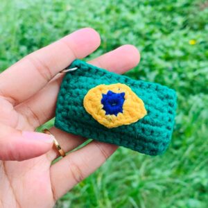 Handmade green Crochet Mini Pouch Keychain with yellow and blue flower