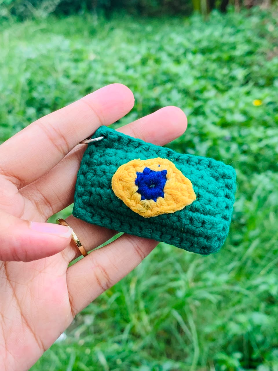 Handmade green Crochet Mini Pouch Keychain with yellow and blue flower