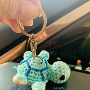 Crochet Turtle Keychain with blue spiral shell and silver metal clasp