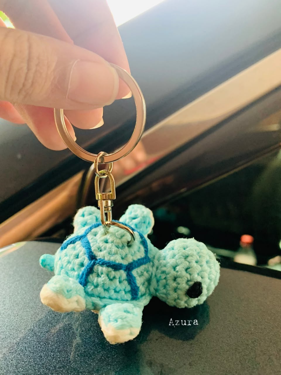 Crochet Turtle Keychain with blue spiral shell and silver metal clasp