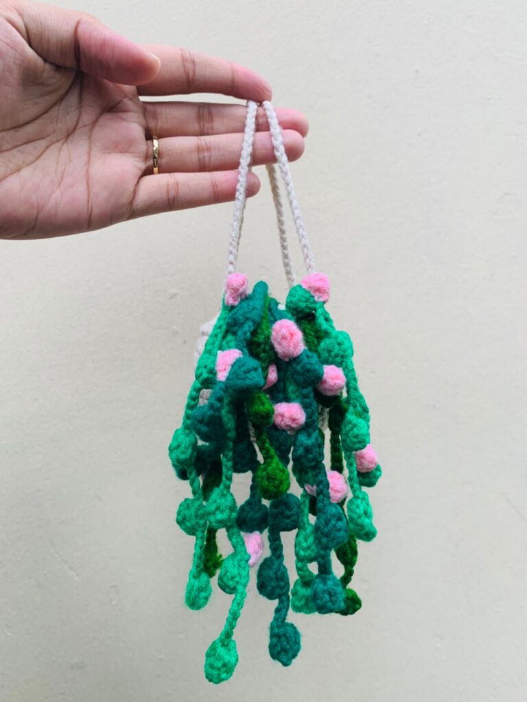 Handmade Crochet Hanging Plant Decor Crochet Hanging Plant Decor with green vines and pink flowers